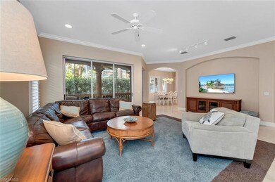 Living room with ceiling fan with notable chandeli
