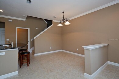Dining room with oversized tile flooring and crown
