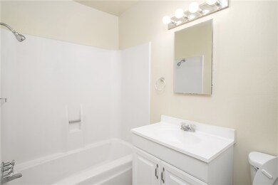 Bathroom featuring vanity, toilet, and  shower com