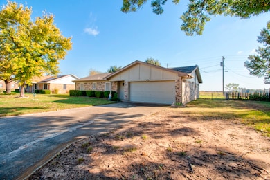Single story home featuring board and batten siding, concrete driveway, and a garage