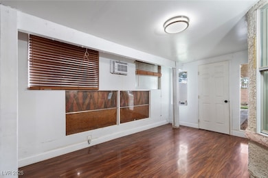 Foyer entrance with wood finished floors, a wall m