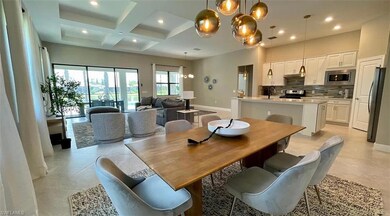 Dining area featuring sink, coffered ceiling, beam