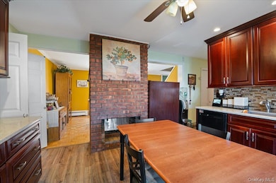 Kitchen featuring wood burning, fireplace