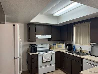Kitchen featuring light tile patterned floors, sin