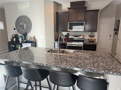Kitchen with stainless steel appliances, dark brow