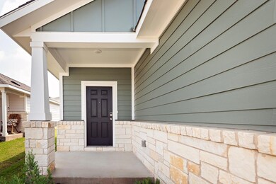 View of exterior entry with a porch