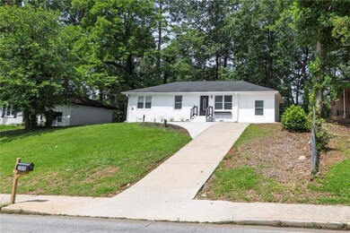 Single story home featuring a front lawn and concrete driveway