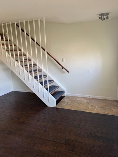 Stairway featuring baseboards and wood finished f
