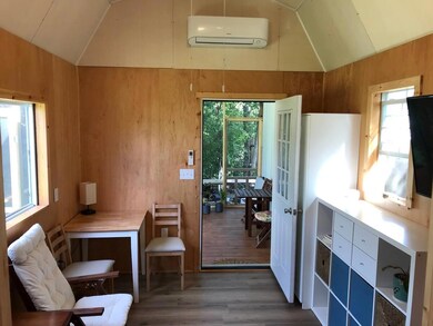 Sitting room featuring wood walls, dark wood fini