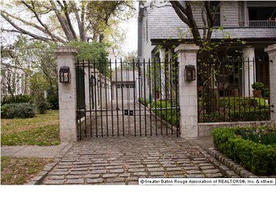 TWO SETS OF GATES LEADING TO A TWO CAR GARAGE.