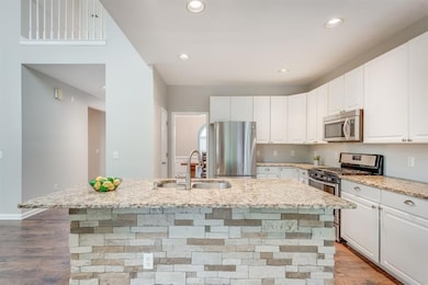 Enjoy cooking in this beautiful upgraded eat-in kitchen with stainless steel appliances and granite countertops.