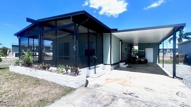 View of front facade with a sunroom, a carport, an
