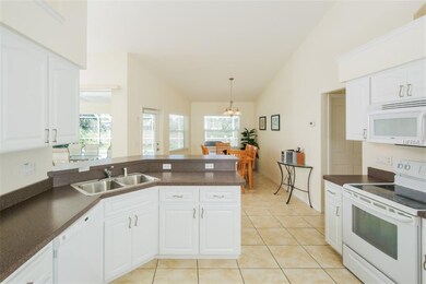 White Kitchen featuring Breakfast Bar, vaulted cei