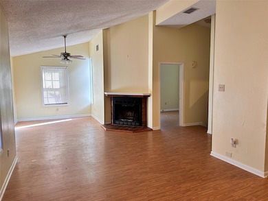 Unfurnished living room featuring lofted ceiling,