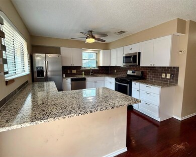 Kitchen with stainless steel appliances, a sink, 