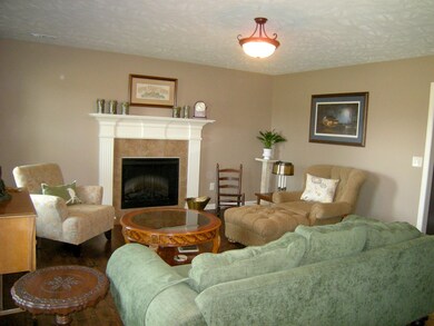 The great room has plenty of space for even large pieces of furniture and a cozy fireplace for crisp fall evenings. There are sparkling hardwood floors throughout the downstairs. 