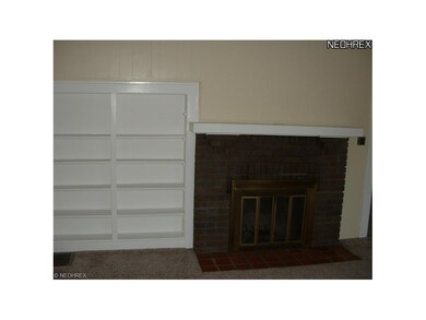 Wood burning fireplace and built in bookshelves.
