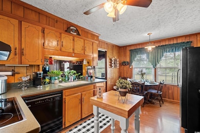 Kitchen featuring a ceiling fan, a sink, a texture