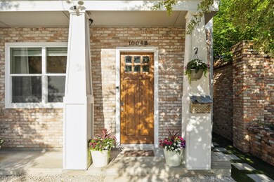 Charming brick exterior with a wooden front door,
