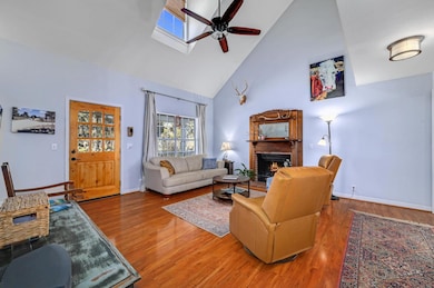 Living room featuring wood finished floors, a cei