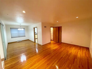 Living room and Dining Room combo. Front door is located behind the closet door, and kitchen is through the doorway in the dining room