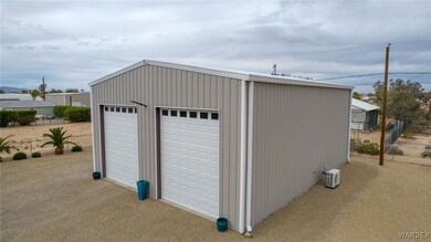 Detached garage featuring fence