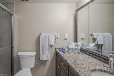 Updated Bathroom with granite counter, tile floor, refinished cabinets.