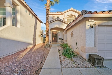 View of exterior entry featuring a garage, a tile