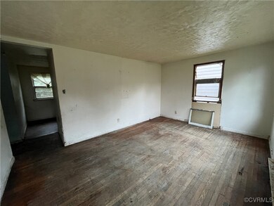 Spare room with dark wood-type flooring and a text