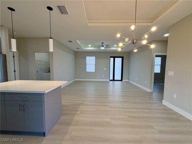 Unfurnished living room with a tray ceiling, ceili