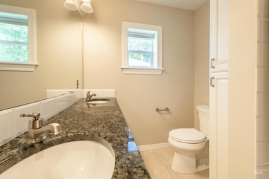 Full bathroom with toilet and double vanity