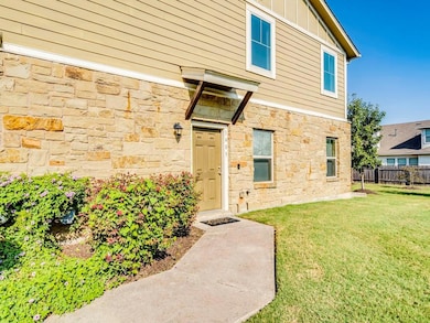 Doorway to property featuring stone siding and bo