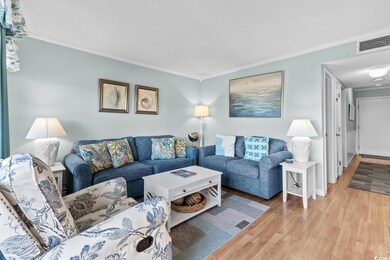 Living room featuring ornamental molding and light