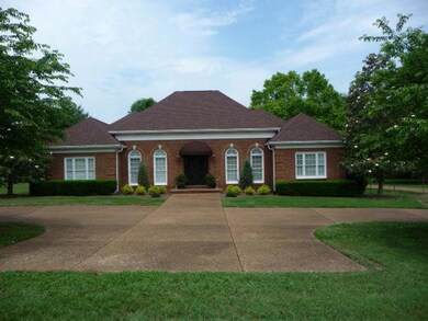 Another front view showing circular drive and extra parking.