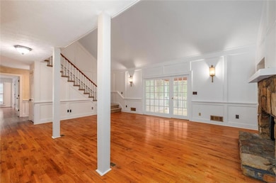 Unfurnished living room with stairs, a decorative 