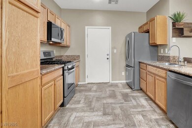 Kitchen with stainless steel appliances, a sink, l