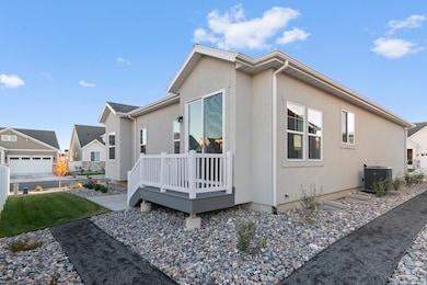 View of side of home featuring a deck, stucco siding, a residential view, and a yard