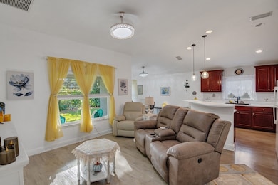 Living area featuring light wood-style floors and recessed lighting