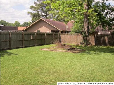 Private fenced back yard with double gates to stor