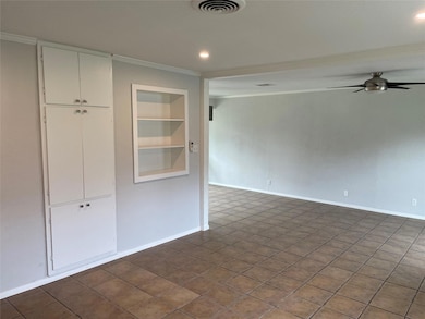 Empty room with ornamental molding, built in shel