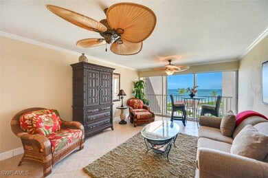Tiled living room featuring ornamental molding, a