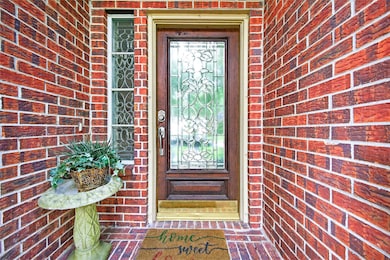 Charming Front Entry – Brick-lined entryway with d