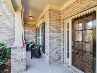 Welcoming front porch and gorgeous wood door with 