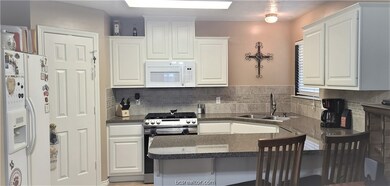 Spacious kitchen with quartz countertops, tile backsplash, & huge pantry!  Refrigerator does not convey but all other appliances stay with the home.  Gas range and stainless dishwasher replaced less than 1 year ago.