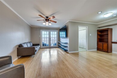 Unfurnished living room featuring ceiling fan, light hardwood / wood-style floors, french doors, and crown molding