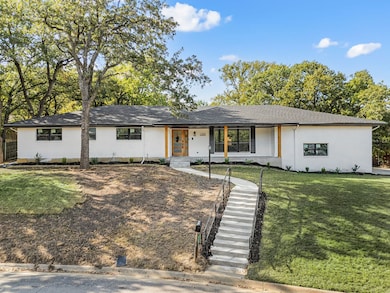 Ranch-style home featuring a front yard, a porch, stucco siding, and a shingled roof