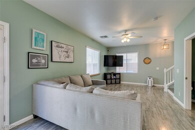 Living area featuring stairway, wood finished floo