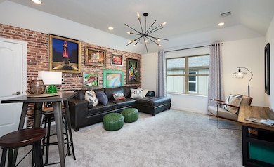 Carpeted living room featuring brick wall, visibl