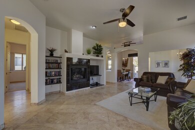 Open LR with fireplace & custom shelving