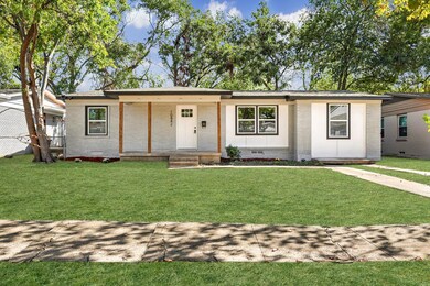 Single story home featuring a front lawn